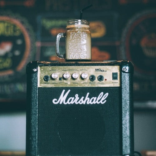 marshall practice amp with iced coffee in mason jar, sitting on top of the amp