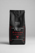Coffee label for TMG Coffee Co. with 'The Monahan Grind' and 'Dark Roast' text on a black background.
